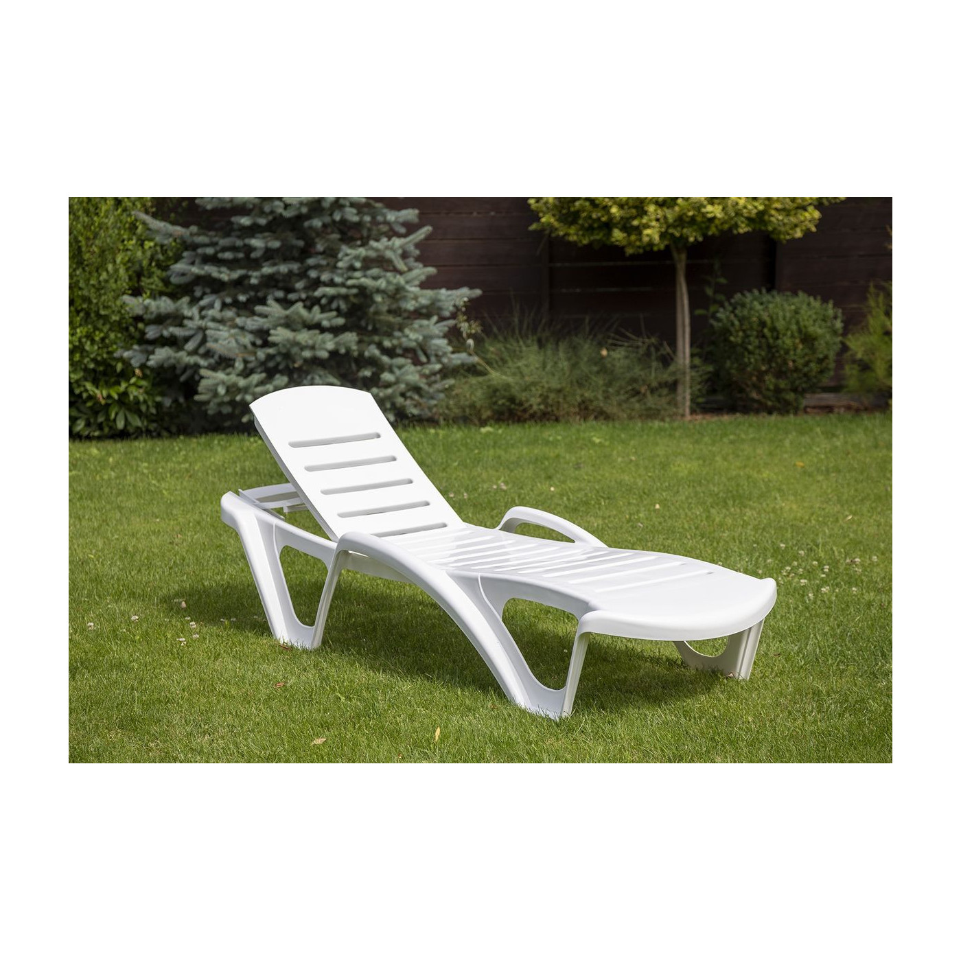 Biały leżak monoblock w ogrodzie